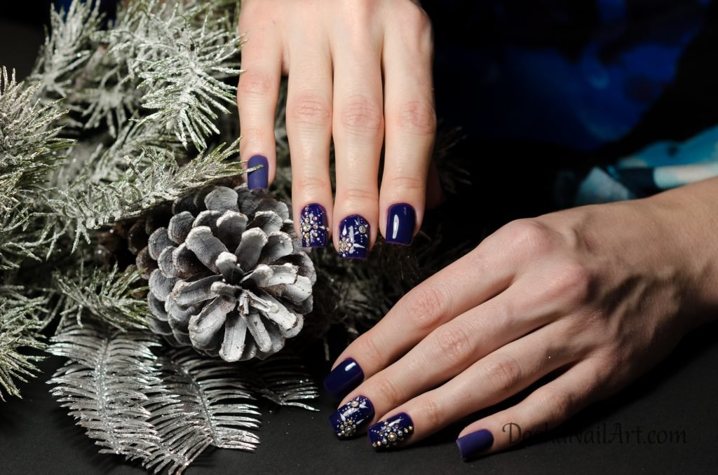 Christmas diamond snowflake nail design in the blue color
