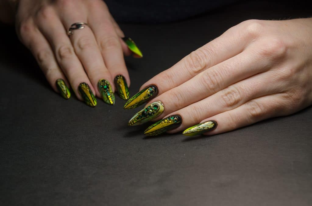 Luxury graphic Edge nails in the green-gold marble colors and diamonds